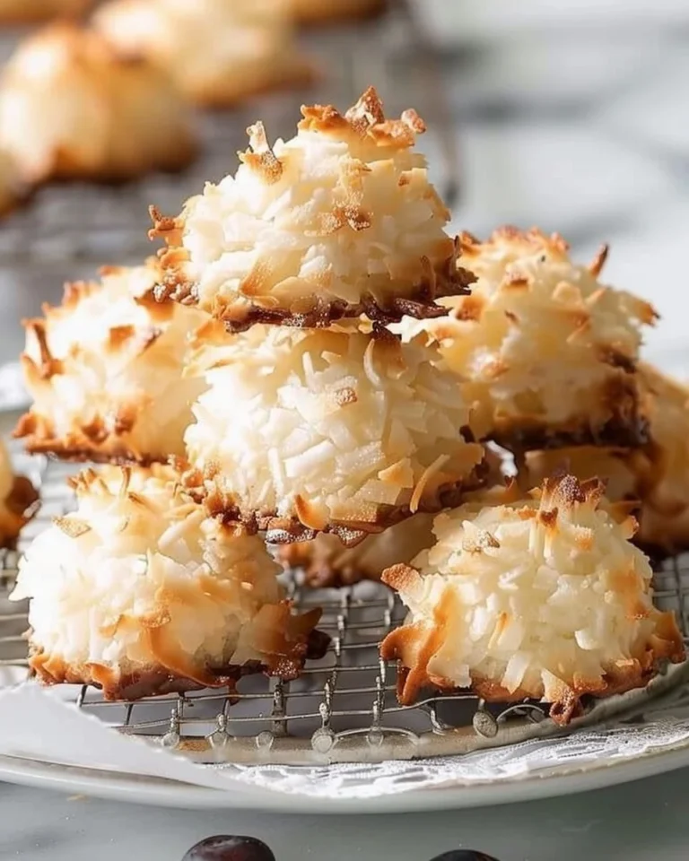 A plate of homemade coconut macaroons with a golden-brown exterior