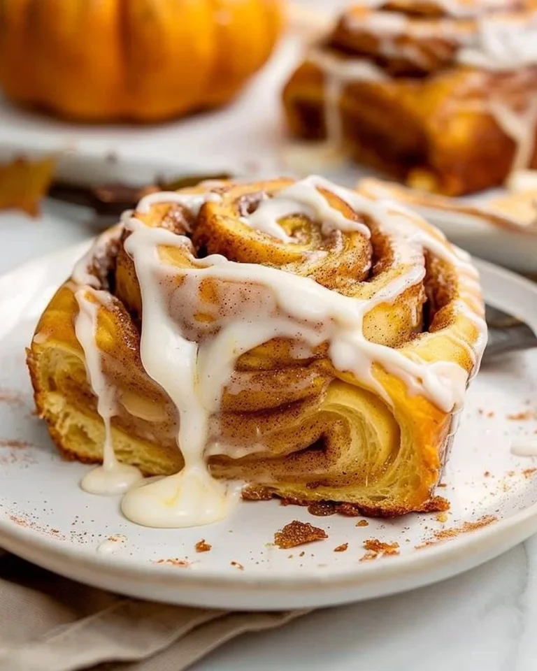 Delicious pumpkin cinnamon rolls drizzled with icing for a cozy treat