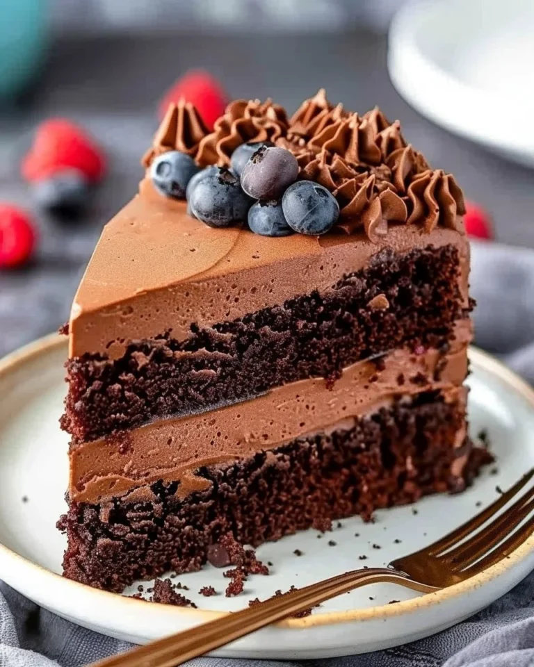 Deliciously decadent chocolate mousse cake topped with whipped cream and chocolate shavings.
